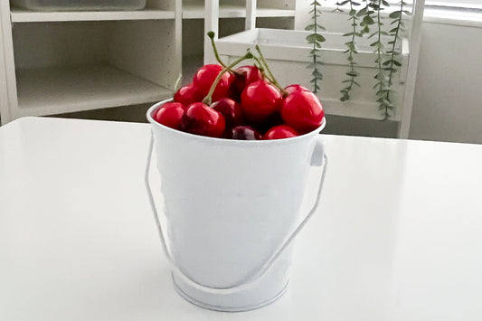 A bucket of cherries in a classroom 