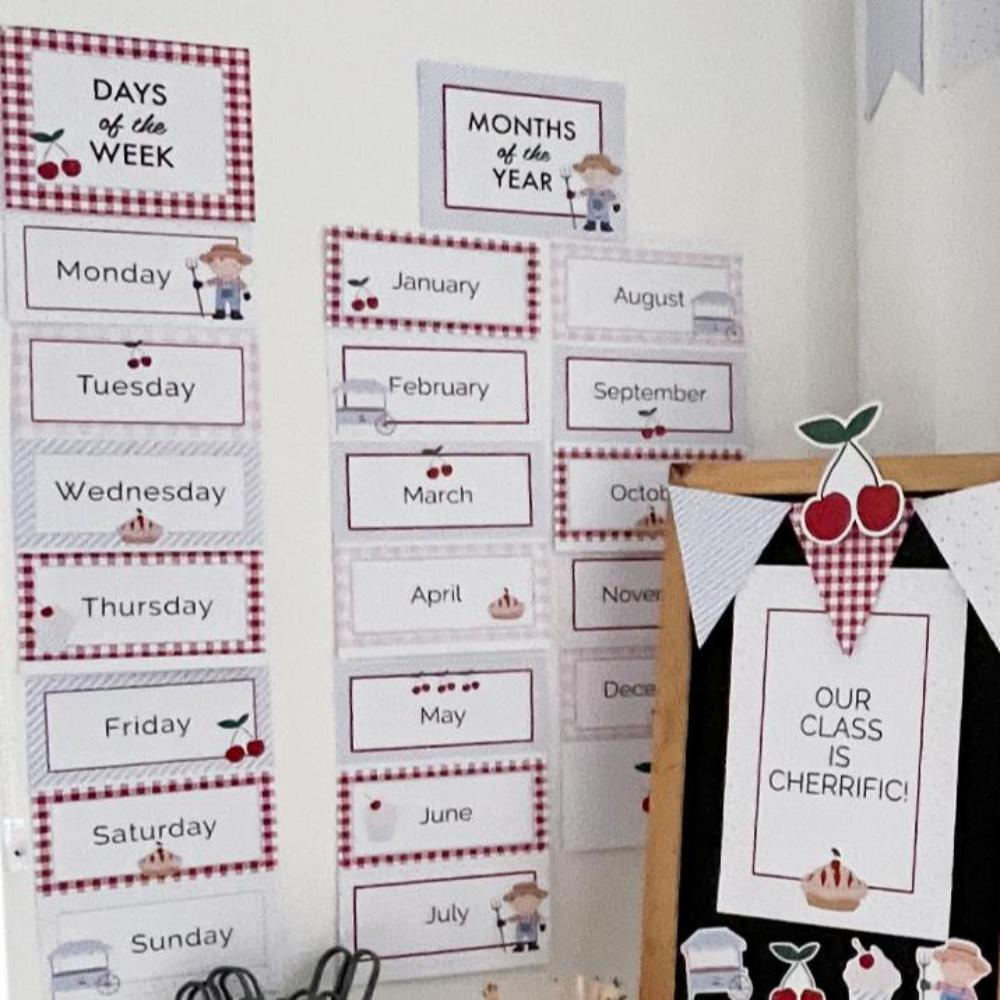 Days of the week and months of the year printable in a cherry theme. Set up in a classroom.