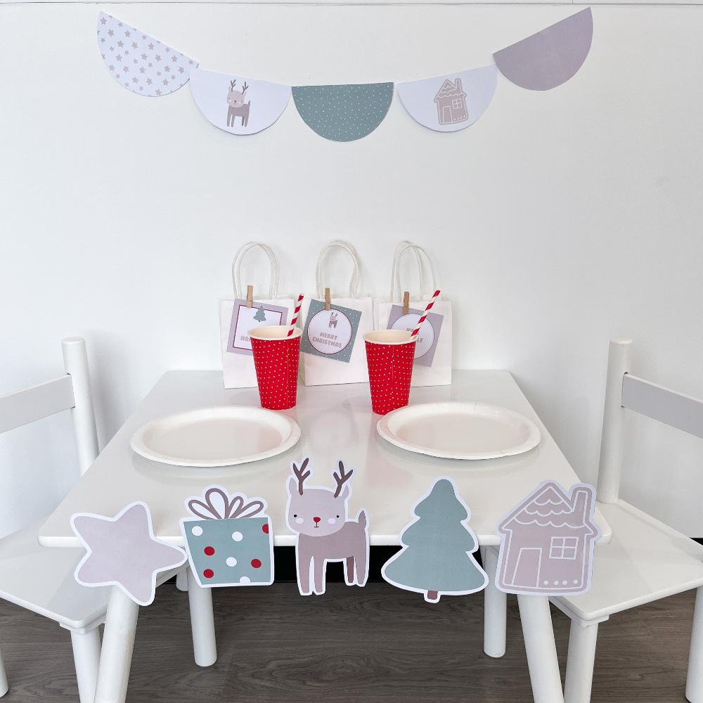 Cute Christmas party set up for kids with bunting and beige coloured graphics