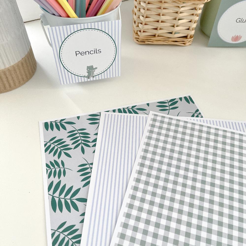 Pale blue and Sage green papers for classroom, craft or party decoration. Displayed on a desk.